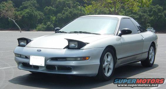 Silver 1993 Ford Probe parked outside with pop-up headlights up