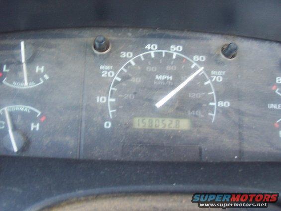 Dashboard gauges showing speed, fuel, and temperature. Odometer reads 158052.8