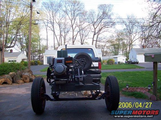 Trailer with engine and spare tire hitched to rear of 1990 Ford Bronco