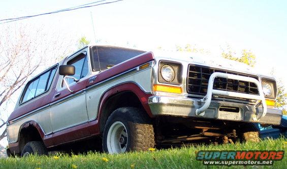 Ford Bronco with two-tone paint and a brush guard, parked on grass