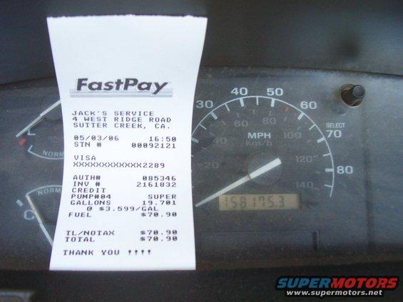 Dashboard with speedometer and FastPay receipt dated 05/03/86