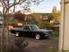 1968 Ford Ranchero - A black 1968 Ford Ranchero pickup truck is parked in a driveway with a red pickup truck in the background.