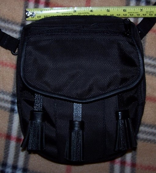 Black sporran with three tassels and a measuring tape above it
