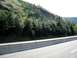 1969 Mercury Cougar - A scenic view of a highway bordered by trees and a concrete barrier, with the Supermotors.net logo in the corner.