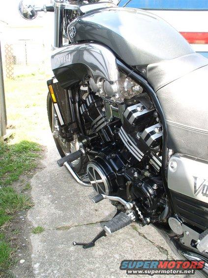 Gray Yamaha motorcycle engine and side panel, parked on concrete