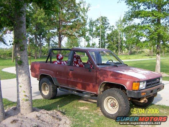 Maroon 1984 Toyota 4Runner with floral seat covers parked outdoors