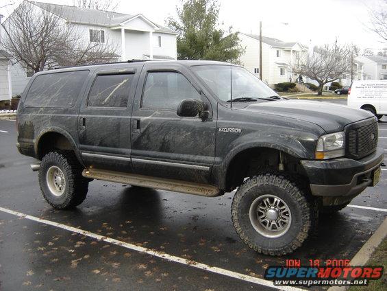 Black lifted 2003 Ford Excursion side view with aftermarket wheels