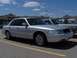 2002 Ford Crown Victoria - Silver 2002 Ford Crown Victoria parked in a shopping center lot under a blue sky.