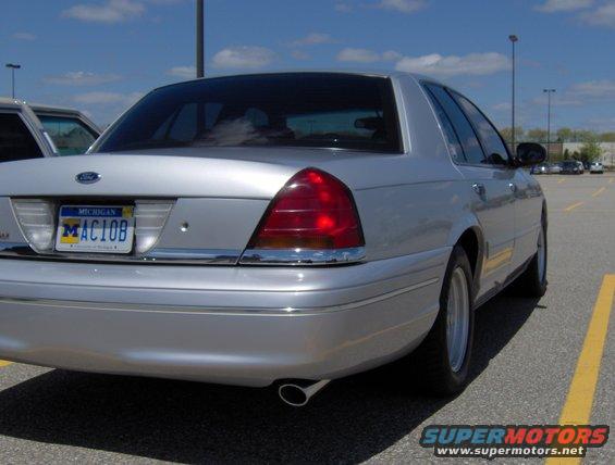 Silver 2002 Ford Crown Victoria sedan, rear 3/4 view, parked in a lot