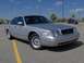 2002 Ford Crown Victoria - A silver 2002 Ford Crown Victoria is parked in a lot under a blue sky.