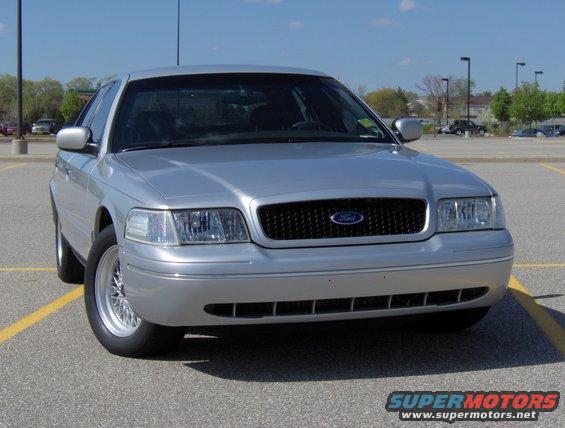 Silver 2002 Ford Crown Victoria parked in a lot, front view