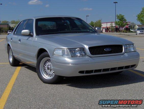 Silver 2002 Ford Crown Victoria parked in a lot, front 3/4 view