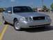 2002 Ford Crown Victoria - A silver 2002 Ford Crown Victoria is parked in a lot with yellow lines.