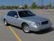 2002 Ford Crown Victoria - A silver 2002 Ford Crown Victoria is parked in a lot, showing its front grille and headlights.