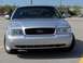 2002 Ford Crown Victoria - Front view of a silver 2002 Ford Crown Victoria parked in a lot.