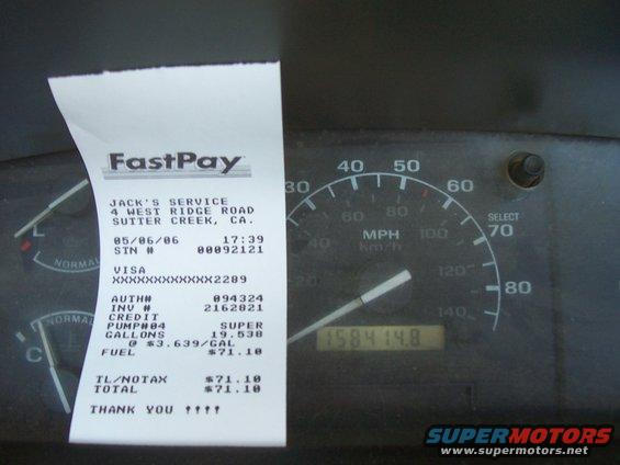 Interior view of a speedometer and a FastPay receipt from Jack's Service