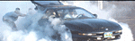 Black 1996 Ford Probe with smoke, person exiting driver's side