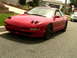 1993 Ford Probe - A red 1993 Ford Probe is parked on a residential street with a white car in the background.