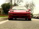 1993 Ford Probe - A red 1993 Ford Probe is parked on a residential street, viewed from a low angle.