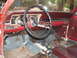 1966 Ford Ranchero - The interior of a classic car shows significant wear and tear, with peeling paint and a dirty floor.