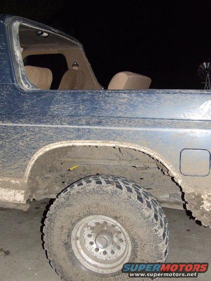 Mud-covered 1986 Ford Bronco rear side view, showing tire and quarter panel