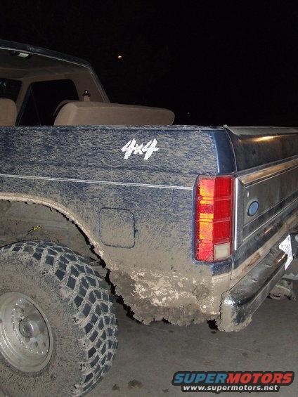 Mud-covered 1986 Ford Bronco rear quarter panel with 4x4 decal