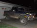 1986 Ford Bronco - This lifted Ford Bronco is covered in mud, suggesting recent off-road use.