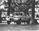 1965 Ford Mustang - A 1965 Ford Mustang race car is captured airborne on a track, displaying its racing livery and number 39.