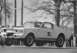 1965 Ford Mustang - This 1965 Ford Mustang GT 350 is captured mid-air during a race, displaying its iconic racing stripes and number 98b.