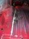 1978 Ford Bronco - The interior floor of a vehicle shows signs of rust and previous repairs, with a prominent seam running down the middle.