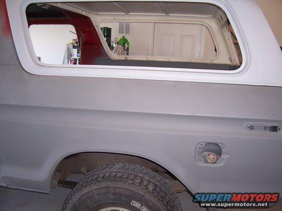 1978 Ford Bronco rear quarter panel with fuel door open, primer finish