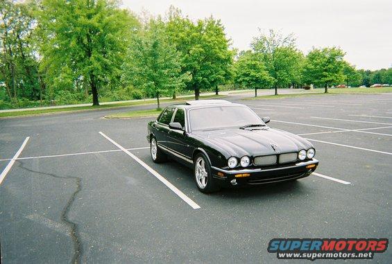 Black Jaguar XJ parked in a lot, 3q-front view