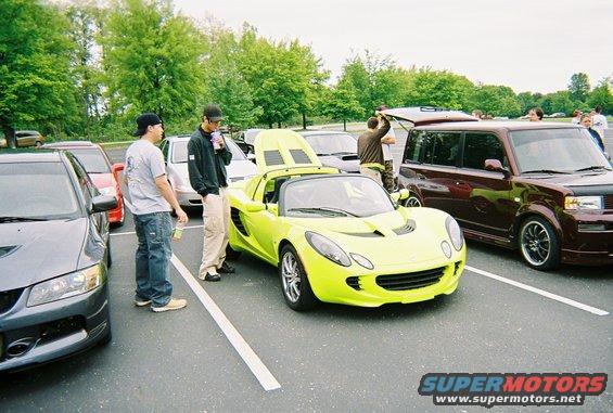 Lime green sports car, front view, with hood open