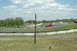 1993 Ford Mustang - A red 1994 Ford Mustang GT navigates a curve on a race track, with another car in the distance.