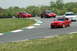 1993 Ford Mustang - Multiple Ford Mustangs participate in a track day event on a sunny afternoon.