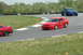 1993 Ford Mustang - Two Ford Mustangs, a red one and a blue one, compete on a race track.