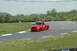 1993 Ford Mustang - A red Ford SVT Lightning pickup truck navigates a turn on a race track.