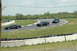 1993 Ford Mustang - Three cars, including a 1993 Ford Mustang, race on a track with grassy verges.