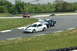 1993 Ford Mustang - A white Ford Mustang races on a track alongside other vehicles.