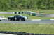 1993 Ford Mustang - A classic Ford Mustang race car with number 84 competes on a sunny day at a track.