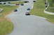 1993 Ford Mustang - Multiple cars are seen on a race track during a sunny day.