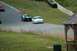 1993 Ford Mustang - Multiple Ford Mustangs race on a track, including a white 1996 GT and a black classic model.