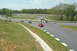 1993 Ford Mustang - A red 1993 Ford Mustang navigates a turn on a sunny day at the racetrack.
