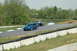 1993 Ford Mustang - A 1993 Ford Mustang races on a track alongside other vehicles.