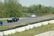 1993 Ford Mustang - Multiple cars compete on a race track with trees and barriers visible.