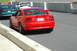 1993 Ford Mustang - Red Mustang Cobra SVT with a large rear spoiler and custom 'COBRAR' license plate.