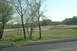 1993 Ford Mustang - A race track scene with trees and cars on the course.