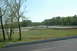1993 Ford Mustang - A scenic view of a race track with several cars in motion under a bright, clear sky.