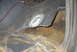 1994 Ford Bronco - The interior floor shows extensive rust and damage, with metal cut away to reveal the undercarriage.