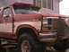 1986 Ford Bronco - This Ford Bronco has a two-tone paint job and a prominent aftermarket bull bar on the front.